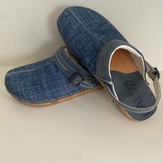 Denim Clogs With Negative Heels, New In Box (No Top) Casual Blue Mules With Cushioned Footbed, Blue Leather Casual Clogs, Casual Blue Leather Clogs, Casual Blue Mules With Rubber Sole, Comfortable Blue Closed Toe Mules, Comfortable Blue Leather Clogs, Casual Blue Clogs With Wooden Heel, Blue Slip-on Mules With Wooden Heel, Comfortable Blue Closed Toe Clogs