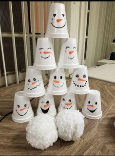 snowmen made out of cups sitting on top of a table