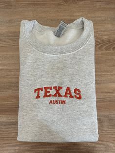 If you want a custom order or have any questions, please message me! -Austin Texas embroidered crewneck -50/50 cotton/polyester -Unisex sizing: fits true to size. Order one size up for a looser fit. Ut Austin Sweatshirt, Crew Neck T-shirt With Letter Embroidery For College, Custom Embroidered Relaxed Fit Crew T-shirt, Relaxed Fit Crew T-shirt With Custom Embroidery, Custom Embroidered Crew T-shirt For College, Custom Embroidery Crew T-shirt For College, College Crew T-shirt With Custom Embroidery, Crew Neck T-shirt With Custom Embroidery, Cotton Crew Neck Sweatshirt With Embroidered Graphics