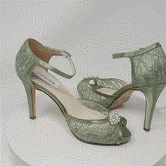 a pair of green high heel shoes sitting on top of a cake