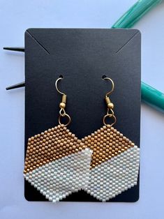 a pair of earrings made out of beads