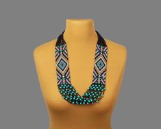 "The geometric pattern and combination of turquoise and black beads make this necklace a unique jewelry. This seed bead necklace can be worn with both casual and formal outfits, adding a touch of bohemian flair to any ensemble. Folk necklace is carefully handmade to ensure attention to detail and durability. ------------- The combination of high quality Czech beads and strong nylon thread guarantees the durability of this necklace. SIZE: length - 14.2 inches (36 cm)           width - 3.15 inches ( 8 cm) -------------- How to keep handmade jewelry in perfect condition? It is best to store bead jewelry in a special box. This will protect your jewelry from sunlight, moisture and air. Avoid water and dust if you want your folk necklace to last as long as possible. ----------------- Important i Turquoise Beaded Necklaces With Black Beads For Festival, Turquoise And Black Beads Necklace For Jewelry Making, Artisan Black Beaded Chain Jewelry, Black Artisan Beaded Chain Jewelry, Turquoise Jewelry With Black Beads For Festival, Turquoise Jewelry With Black Beads For Gift, Bohemian Black Beads Bib Necklace As Gift, Bohemian Bib Necklace With Black Beads For Gifts, Bohemian Bib Necklace With Black Beads As Gift