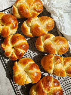 freshly baked croissants on a cooling rack ready to be eaten for consumption