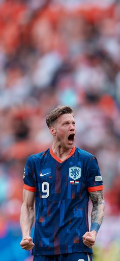 a soccer player with his mouth open in front of an audience