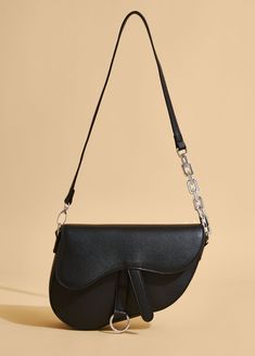 This saddle bag is not just an accessory- it's a statement piece that signals your love for fashion-forwardness mixed with versatility, trendiness and sophistication. Crafted in the ever-classic noir hue from faux leather, this iconic runway darling is a must for the #quietluxury ladies. Iconic Runway, Leather Saddle Bags, Ashley Stewart, Saddle Bag, Pocket Book, Designer Bag, Classic Flap, Personal Marketing, Bra Cups