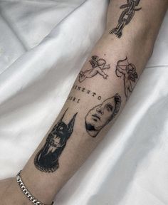 a person's arm with tattoos on it