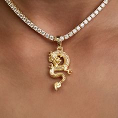 Introducing the Dragon Pendant in 18k Yellow Gold. The dragon is a symbol of power, strength, and good luck for those worthy. Carefully crafted with the utmost attention to detail, we bring this mythical creature to life with this intricate piece. Pair it with a Diamond Tennis Necklace for added shine! This product is guaranteed for life - GLD will repair the item should you experience any defects in craftsmanship or breakage. Specifications - 17mm x 33mm (Width x Height) - Bail: Fits up to 6mm Gold Dragon Design Jewelry, Gold Jewelry With Dragon Design, Gold Round Jewelry With Dragon Design, Luxury Gold Dragon Design Jewelry, Spiritual Gold Jewelry With Dragon Design, Luxury Gold Jewelry With Dragon Design, Traditional Gold Jewelry With Dragon Design, Luxury Dragon Design Jewelry For Gift, Symbolic Gold Dragon Jewelry