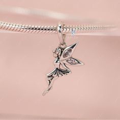 This is charm only, bracelet is sold separate. Enhance your jewelry collection with the addition of this charming pixel fairy pendant charm. Made of solid 925 sterling silver with a platinum plating and adorned with cubic zirconia decoration, this elegant fairy elf design is sure to capture your heart. Add it to your bracelet or necklace, or give it as a gift to a loved one to add a touch of magic and sparkle to their daily wear. Experience the enchantment of this exquisite fairy charm, beautifu Fairy Style Sterling Silver Jewelry, Fairy Style Silver Jewelry For Gift, Elegant Silver Charm Bracelet With Butterfly Charm, Whimsical Sterling Silver Charms Jewelry, Silver Charm Bracelet With Cubic Zirconia, Silver Cubic Zirconia Charm Bracelet, Elegant Sterling Silver Butterfly Charm, Whimsical Silver Charms For Gifts, Whimsical Silver Jewelry With Butterfly Charm