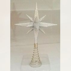 a glass ornament with a star on top