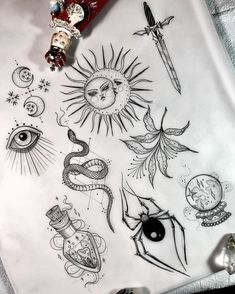 a sheet of paper with tattoos on it and an eye, sun, snake, dragon, moon