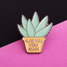 a pin with the words aloe you vera much in gold and green on it