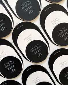 black and white business cards are arranged in rows on a table with the words lunch written below them