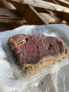 a piece of meat sitting in a plastic container