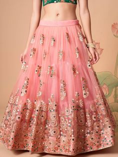 Become the subject of everyone’s conversation by outfitting in this delightful peach color lehenga made with net material designed with mirror work, thread embroidery, and sequin work. This peach lehenga comes with a green color art silk material choli made with embroidery and mirror work. It also comes with a peach color net material dupatta made with thread embroidery and sequin work. This peach lehenga is stitched and can be customized up to 42 inches. The choli will be fully stitched materia Festive Anarkali Embellished Skirt, Traditional Skirt With Mirror Work For Reception, Semi-stitched Skirt With Resham Embroidery For Reception, Reception Skirt With Resham Embroidery, Semi-stitched, Traditional Embellished Skirt For Wedding, Traditional Embellished Wedding Skirt, Anarkali Skirt With Mirror Work For Reception, Bollywood Style Embellished Festive Skirt, Bollywood Festive Embellished Skirt