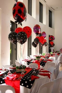 the tables are decorated with red, black and white balloons