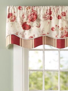 a window with a flowered valance hanging from it's side