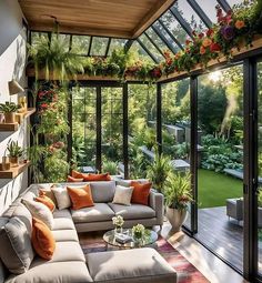 a living room filled with furniture and lots of plants