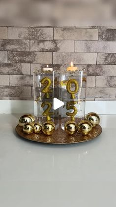 a golden dragon candle holder on a marble counter top with gold balls and candles in it