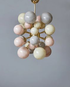 a chandelier hanging from the ceiling with marble balls on it's sides