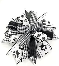 a black and white bow with paw prints on it