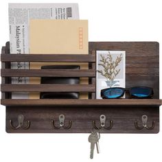 a wooden shelf with keys, glasses and books on it