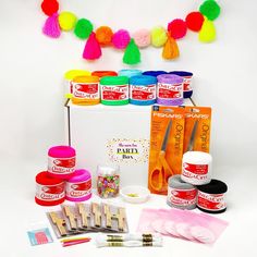 an assortment of crafting supplies including yarn, scissors and pom - poms