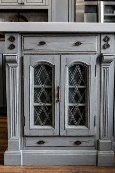 Vintage glass knobs on distressed gray cabinet doors Blue Distressed Kitchen Cabinets, Distressed Cabinets Kitchen, Farmhouse Kitchen Cabinet, Distressed Kitchen Cabinets, Japanese Inspired Bedroom, Distressed Cabinets, Authentic Farmhouse, Cabinet Transformations, Distressed Kitchen