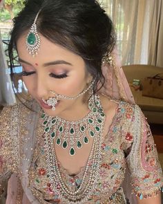 a woman in a bridal outfit with jewelry on her face