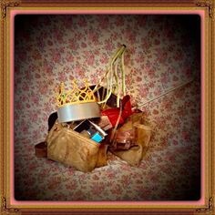 a bag full of items sitting on top of a floral wallpaper covered floor next to a crown