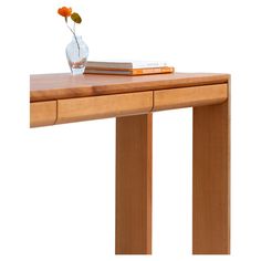 a wooden table with two books and a vase on the top that has an orange flower in it