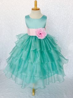 Beautiful organza ruffled dress tailor-made and ready to impress at any upscale event! Handcrafted with the upmost of care and attention to detail, we make sure that each dress is perfectly one of a kind for your little girl. Bridal satin top followed by a satin sash for a nice and snug fit Comes with a flower and matching colored sash. The skirt has layers of cut organza strips which are sewn onto the lining to create the ruffled effect The organza is then sewn at the edges to create those cris Sleeveless Ruffled Princess Dress For Wedding, Sleeveless Bridesmaid Dress For Spring Pageant, Sleeveless Bridesmaid Dress For Spring Pageants, Sleeveless Ruffled Ball Gown For Bridesmaids, Sleeveless Organza Princess Dress For Bridesmaid, Sleeveless Organza Princess Dress For Wedding, Sleeveless Ruffled Ball Gown For Dress-up, Sleeveless Tulle Gown For Birthday, Sleeveless Organza Princess Bridesmaid Dress