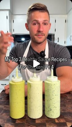 a man sitting at a kitchen counter with three cups in front of him and the words, my top 3 healthy sauce recipes for chicken