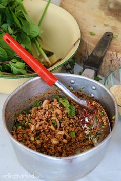 a pan filled with meat and vegetables on top of a table next to other dishes