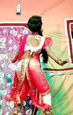 a woman dressed in red and white dancing on stage