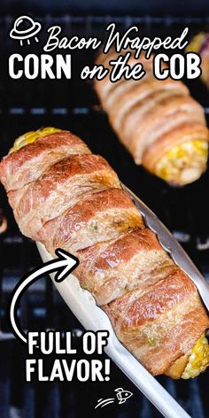 the bacon wrapped corn on the cob is being grilled with a large knife