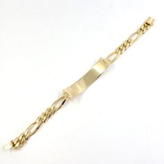 This engravable ID men's bracelet is crafted in 14 Karat yellow gold. Measuring 12.25mm wide, this bracelet features a figaro chain and measures 8 inches in length. With a box clasp and a figure 8 safety clasp. Classic Figaro Chain Bracelets, Classic Engraved Cuban Link Bracelet For Formal Occasions, Yellow Gold Figaro Chain Bracelet With Rectangular Links, Formal Yellow Gold Figaro Chain Bracelet, Classic Gold Bracelet With Figaro Oval Link, Classic Gold Bracelet With Figaro Chain, Classic Gold Bracelet With Figaro Chain And Oval Links, Gold Rectangular Curb Chain Bracelets, Rectangular Gold Bracelets With Curb Chain