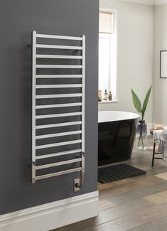 a bathroom with a bathtub, sink and towel rack