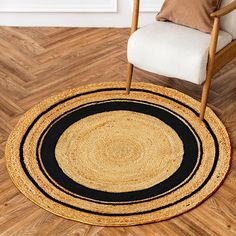 a chair sitting on top of a wooden floor next to a black and tan rug