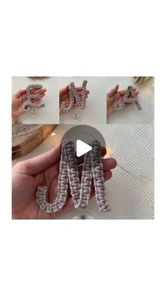 the letters are made out of beads and wire, while someone is holding them in their hand