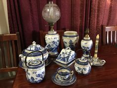 an assortment of blue and white porcelain items on a table