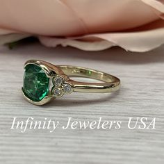 "The ring pictured is lab created emerald and moissanite #6902 Rose Gold is available upon request as a custom order and is a final sale (non refunable, non returnable, non exchangeable). Emerald is the Birthstone for May -Approximate total carat weight: 2.52ctw. diamond equivalent -Center Stone Size: approx. 2.40ct. diamond equivalent -Gem Type: Lab created emerald -Center Stone Shape: cushion cut 8x8mm -Center Stone Color: green, nicest color in emeralds -Center Stone Clarity: VS2 or better -M Gia Certified Moissanite Emerald Promise Ring, Classic Moissanite Emerald Ring For May Birthstone, Green Moissanite Emerald Ring For May Birthstone, Moissanite Emerald Ring For May Birthstone, Emerald Ring With Bezel Setting For Anniversary, May Birthstone, Green Diamond Ring With Bezel Setting, Green Diamond Ring With Bezel Setting, Round Cut, Green Diamond Ring With Bezel Setting In Round Cut, Moissanite Emerald Ring With Center Stone For Anniversary