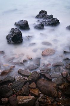 some rocks and water in the ocean