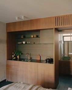 a kitchen with wooden cabinets and black counter tops