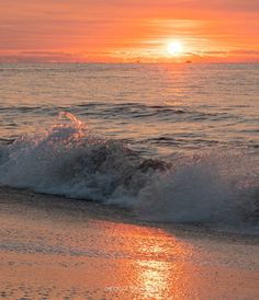 the sun is setting over the ocean waves