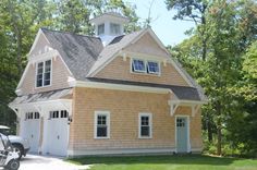 a car parked in front of a house with a steeple on the top floor