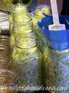 there are many jars with food in them on the table and one is filled with noodles