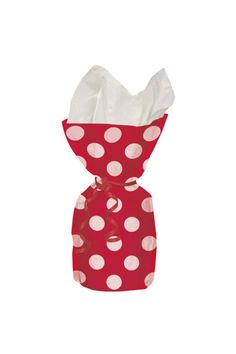 a red and white polka dot bag with tissue