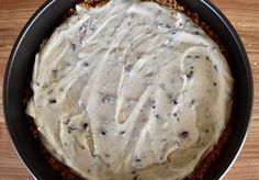 a pie with white frosting in a pan on a table