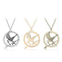 three necklaces with birds in the center, one is gold and one is silver