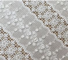 white lace with flowers on grey background